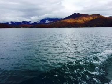 A lake with mountains in the background