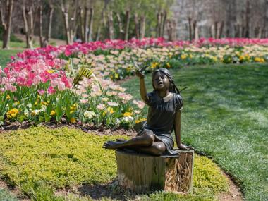 Statue of girl surrounded by tulips at Gibbs Gardens in Ball Ground, Georgia
