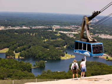 Couple on top of Stone Mountain watching the cable car