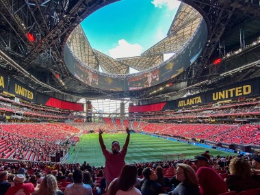 Crowd cheering at an Atlanta United soccer game in Mercedes-Benz Stadium in Atlanta, Georgia