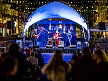 Band playing on the Town Green Stage at Wire & Wood Festival in Alpharetta, Georgia