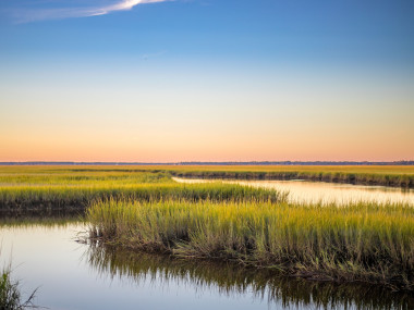 Sunrise over winding waterways and tall marsh grass in Kingsland, Georgia.