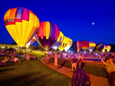 Hot air balloons are lit up under a night sky at Callaway Resort & Gardens