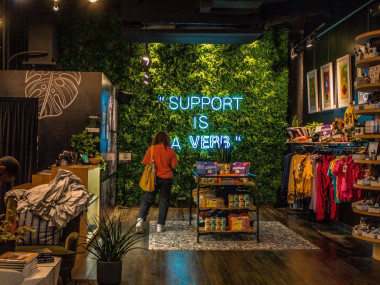 Support is a verb neon sign in Village Retail store in Atlanta, Georgia
