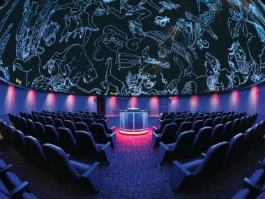 Seats inside a 360-degree planetarium screen