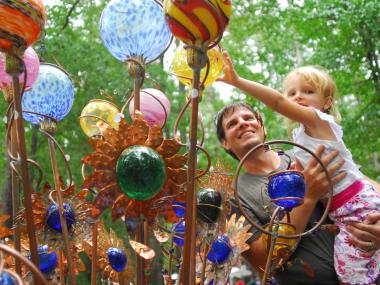 Father and child with art at the Yellow Daisy Festival at Stone Mountain Park