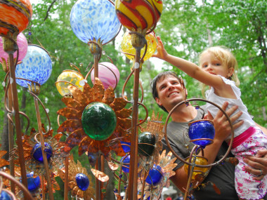 Father and child with art at the Yellow Daisy Festival at Stone Mountain Park