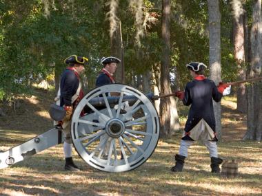 colonial soldier reenactors fire a cannon