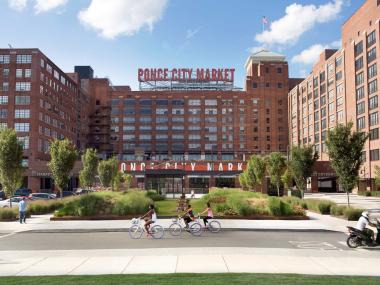 An outdoor market in the city surrounded by buildings