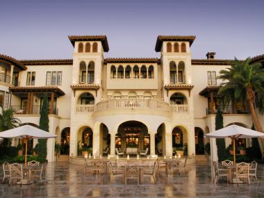 The entrance of a large luxury resort with ivory stonework.