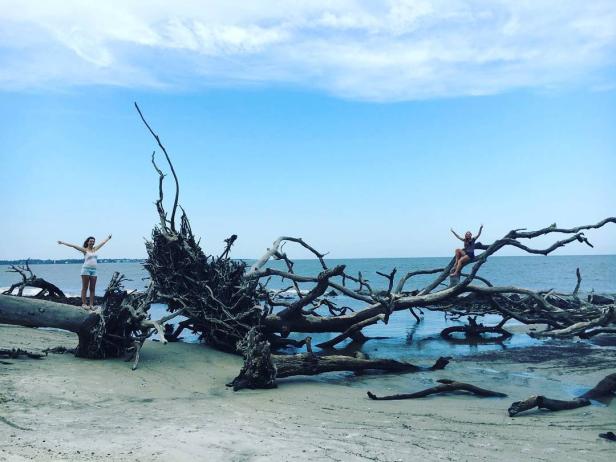 Two girls on Driftwood Beach on Jekyll Island, Georgia. Photo by @stiingwray