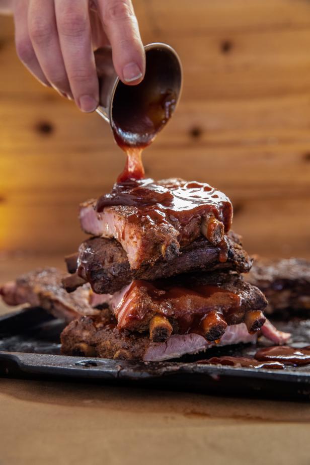 Sauces being poured over barbecue ribs