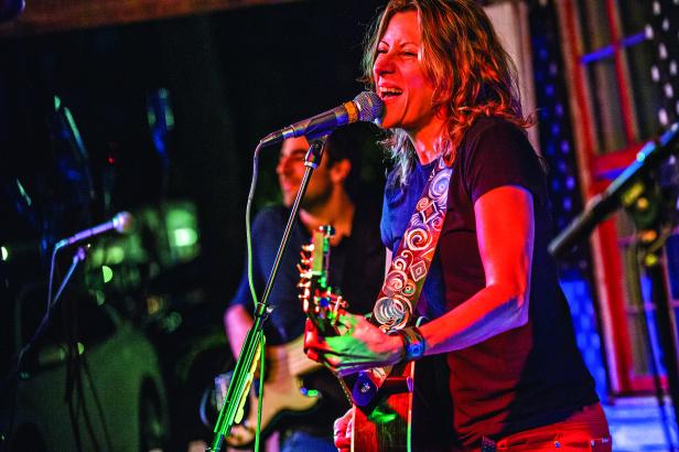 singer and guitarist playing on stage