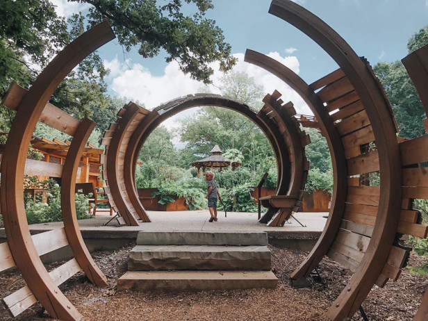 Child framed by a sculpture at the State Botanical Garden of Georgia in Athens, Georgia