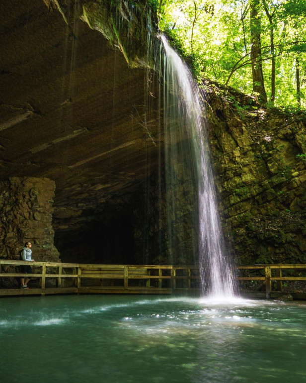 Woman on a walkway under a waterfall at James H. "Sloppy" Floyd State Park in Summerville, Georgia. Photo by @westy4xer