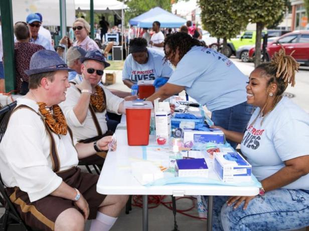 Men dressed in traditional clothing at an information table at Macon Beer Fest in Macon, Georgia