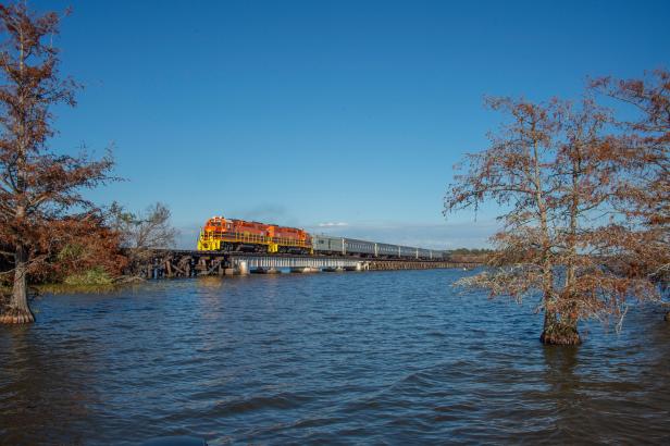 SAM Shortline Excursion Train traveling on a bridge over a lake
