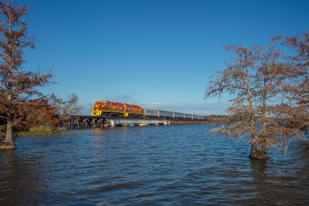 SAM Shortline Excursion Train traveling on a bridge over a lake