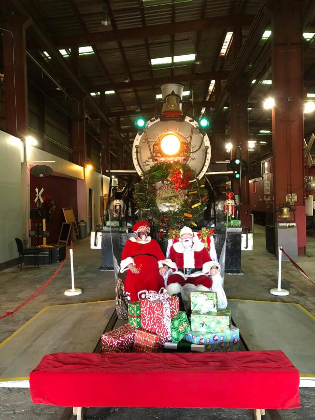 Santa and Mrs. Claus seated in front of a train at the Southeastern Railway Museum in Duluth, Georgia