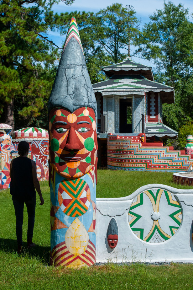 Woman walking in the courtyard at Pasaquan in Buena Vista, Georgia