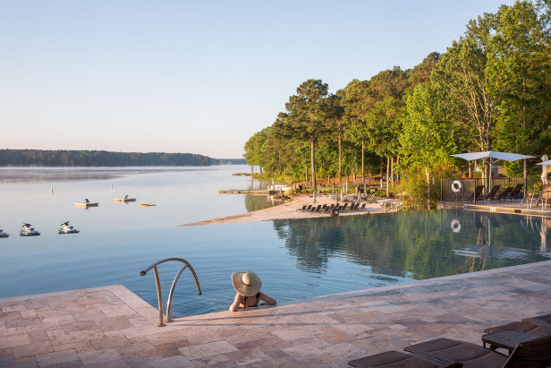 Woman in the infinity pool at The Ritz-Carlton Reynolds, Lake Oconee in Greensboro, Georgia. Photo by @visitlakeoconeega