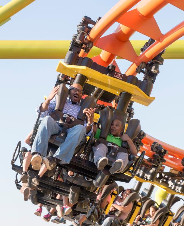Riders on a suspended roller coaster
