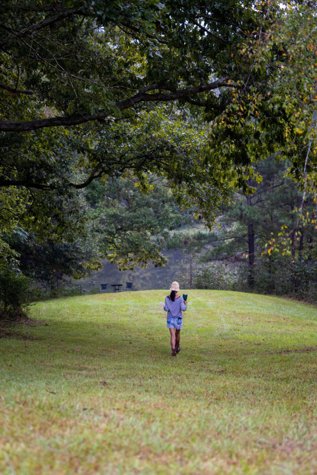 Woman walking in field at Hundred Acre Farm in Madison, Georgia
