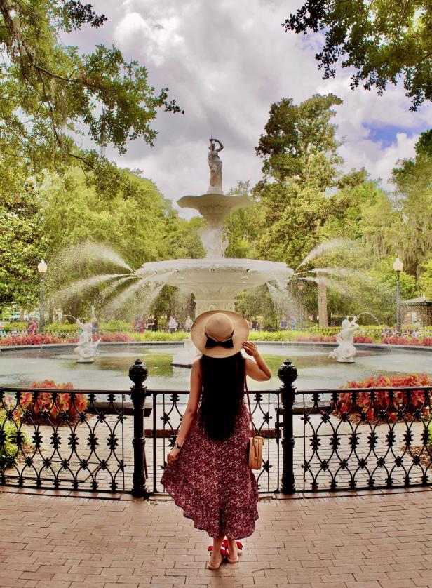 Woman standing near the fountain in Forsyth Park in Savannah, Georgia