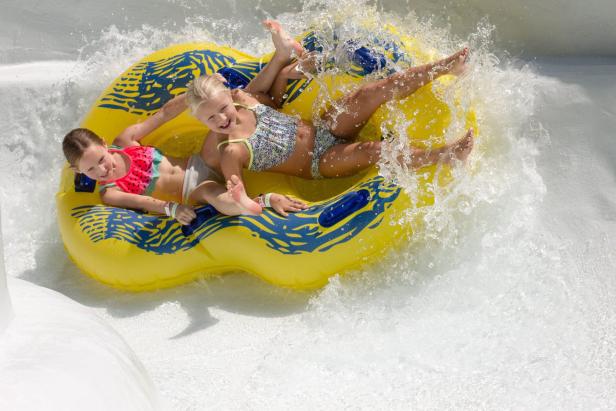 Two kids on a water slide at The Water Park at Margaritaville at Lanier Islands in Georgia