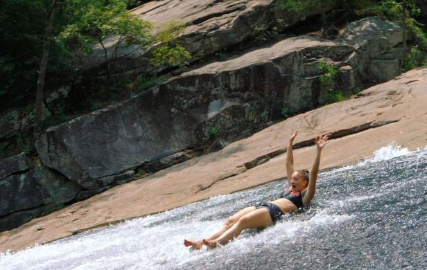 Woman on sliding rock at Tallulah Gorge State Park in Tallulah Falls, Georgia