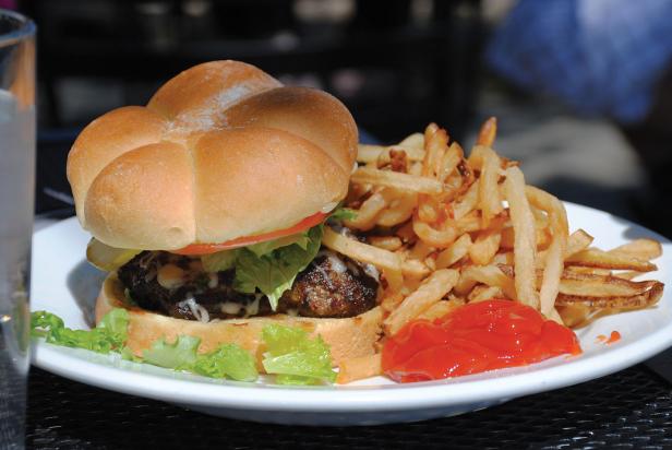 Cheeseburger and french fries on white plate