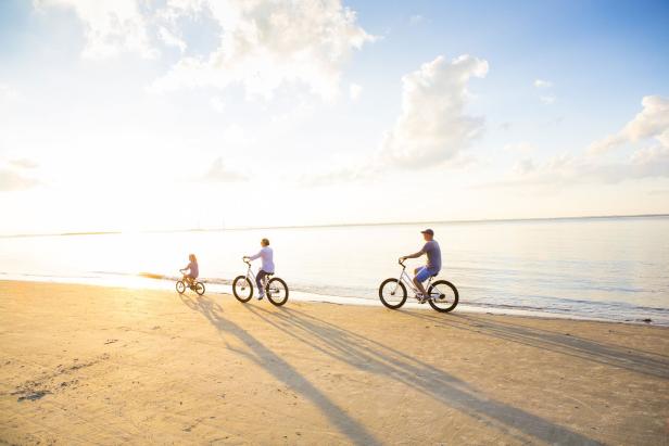 Family biking on St. Andrews Beach on Jekyll Island