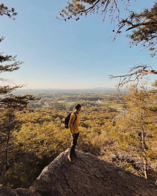 Hiker at an overlook on Sawnee Mountain in Cumming, Georgia