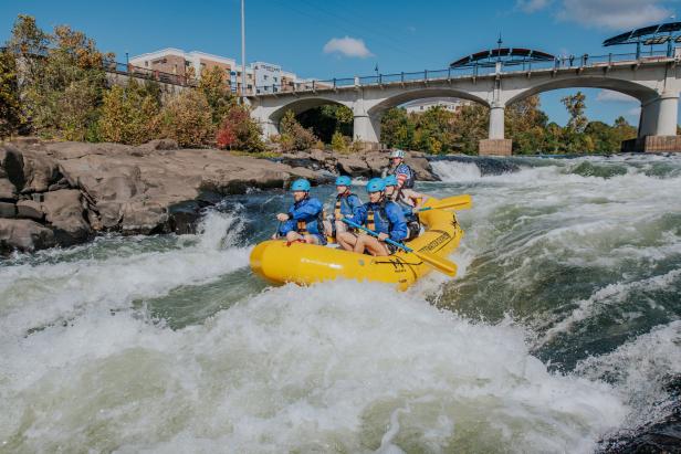 A raft rushes through whitewater rapids