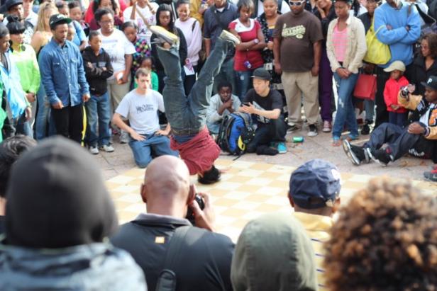 Crowd watching breakdancer at Atlanta Hip Hop Day Festival