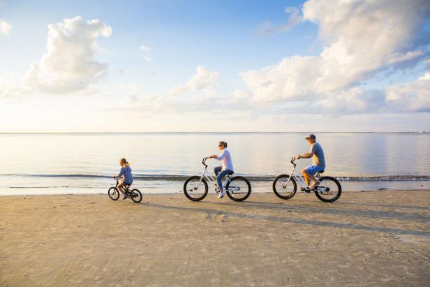 Family biking on the beach