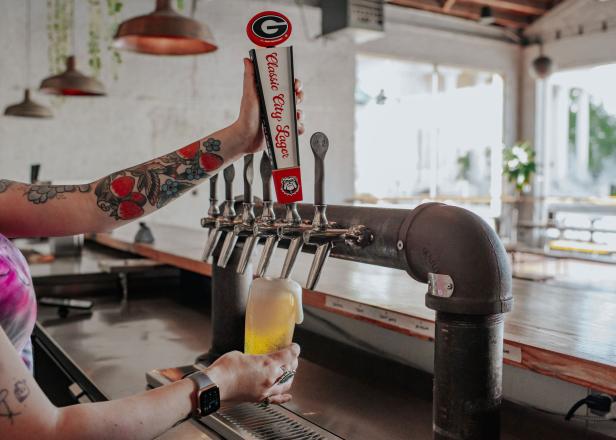 Bartender pouring a Classic City Lager in Athens, Georgia