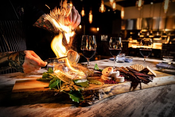 Chef prepares food at Cork and Flame in Evans, Georgia