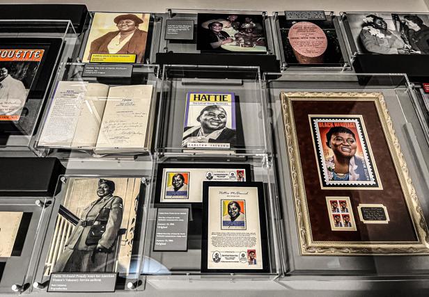 A wall covered with encased pictures of and books about Hattie McDaniel at The Hattie McDaniel Legacy Experience at the Road To Tara Museum in Clayton County Georgia