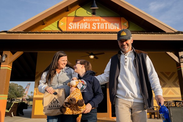 Family walking away from the Safari Station building, smiling and laughing.
