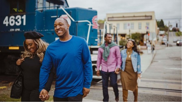 Two couples holding hands walking outside, crossing the street in Blue Ridge.