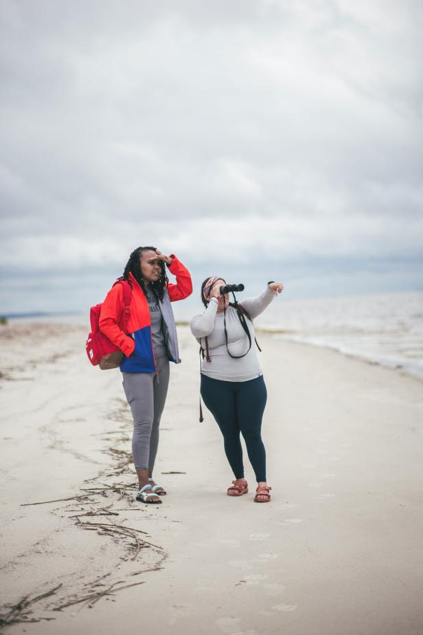 Two women bird watching on the beach on Jekyll Island, Georgia