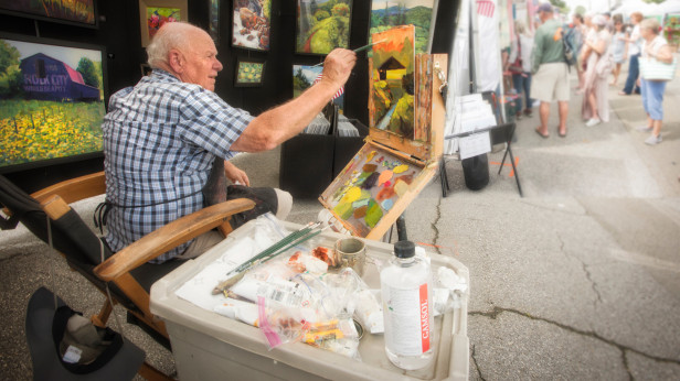 Man painting at an arts festival in Blue Ridge, Georgia