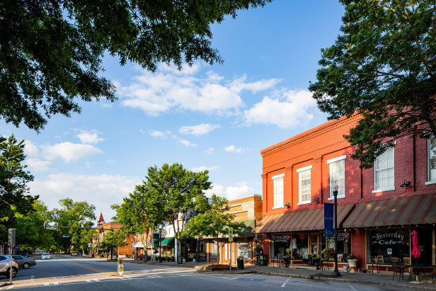 View of a downtown street framed by large trees.