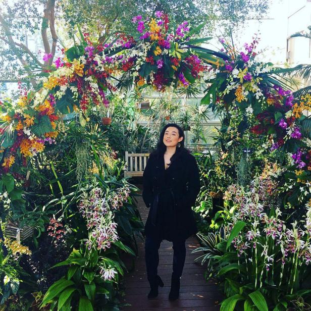 Woman under an arch of flowers at the State Botanical Garden of Georgia in Athens, Georgia