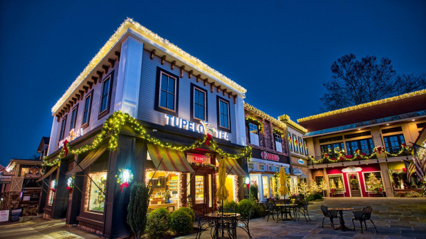 Exterior or a tea shop light up at night in a small town. 