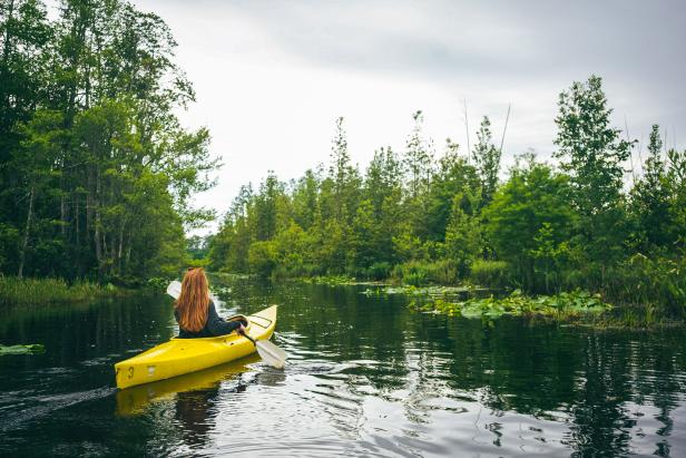 Woman kayaking in the Okefenokee Swamp. Photo by @wandernorthga