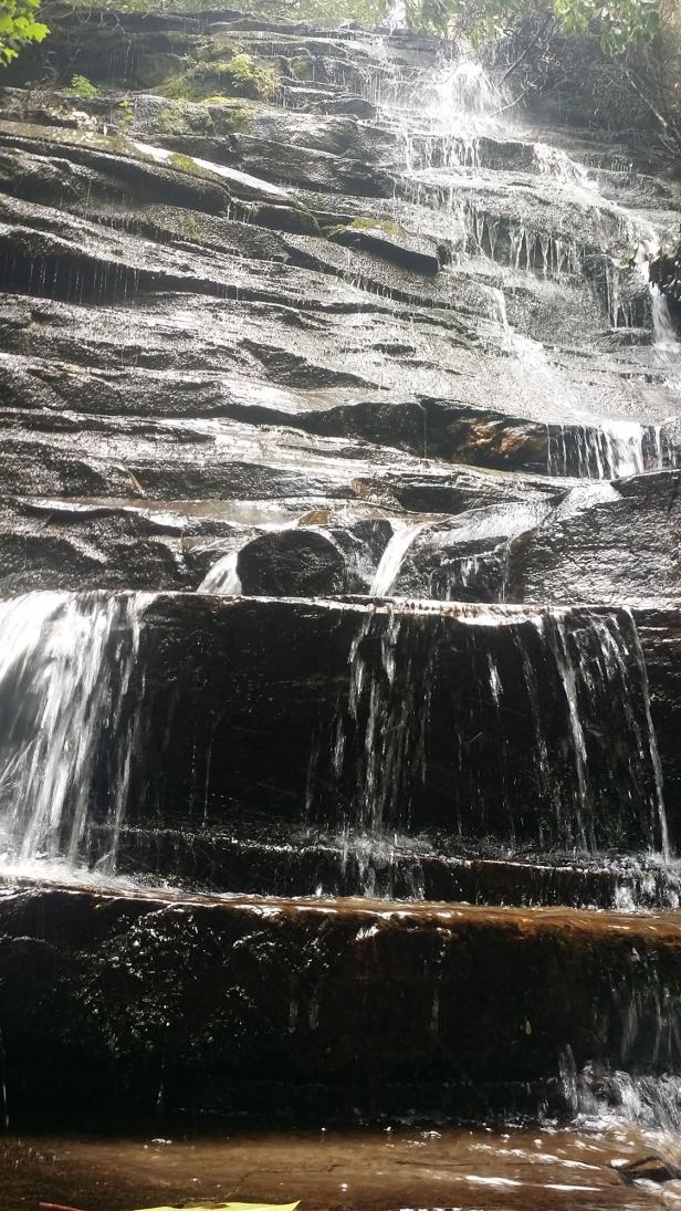 Water flows over large rocks.