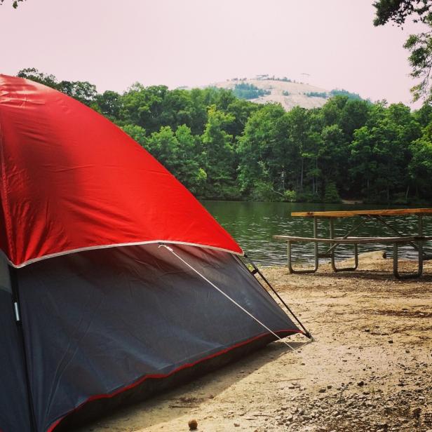 Red tent with Stone Mountain in the background