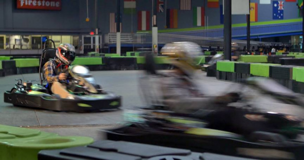 People on go-karts at Andretti Indoor Karting